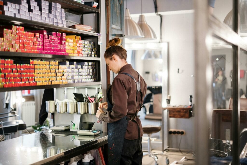 Eine Friseurin mischt Haarfarbe.